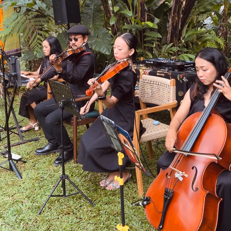 Live string quartet performing at a garden wedding ceremony in Bali