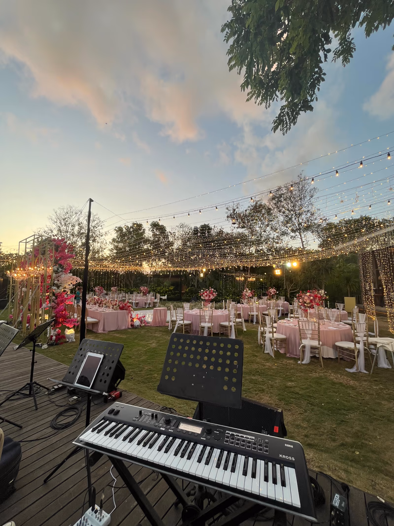 Wedding reception setup with string lights and floral decor in Bali